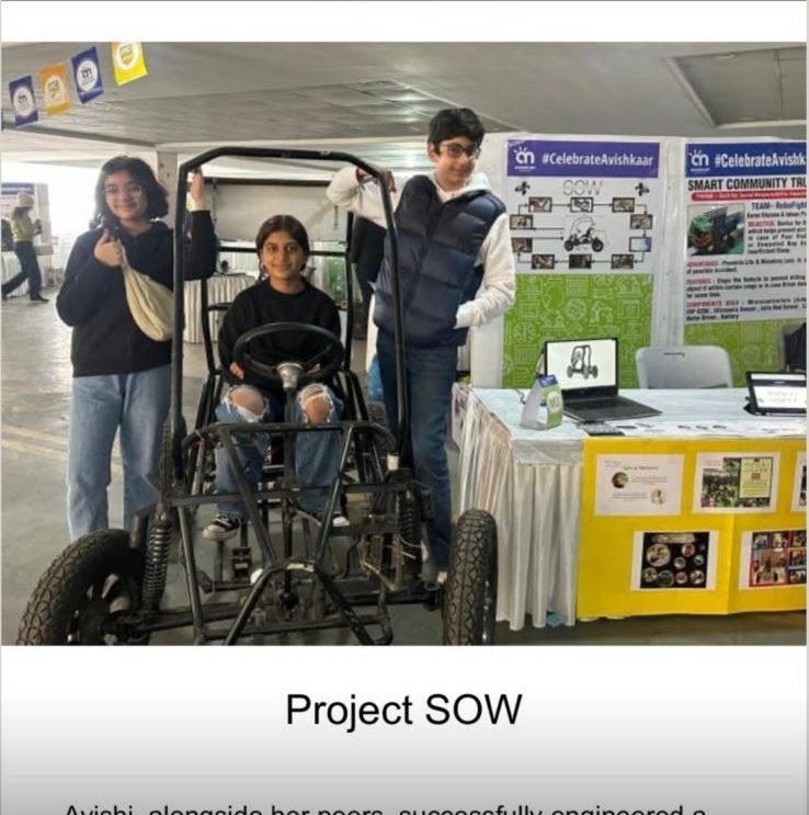 School newsletter item headed Project SOW, with a photo of three students beside the electric vehicle at a display table.